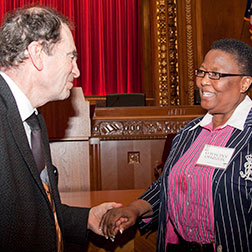 Image of Albie Sachs, former South African Constitutional Court Justice, greeting a visitor after his September 2011 Forum on the Law lecture.