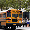 Image of schoolchildren and chaperone outside a schoolbus parked near the Moyer Judicial Center.